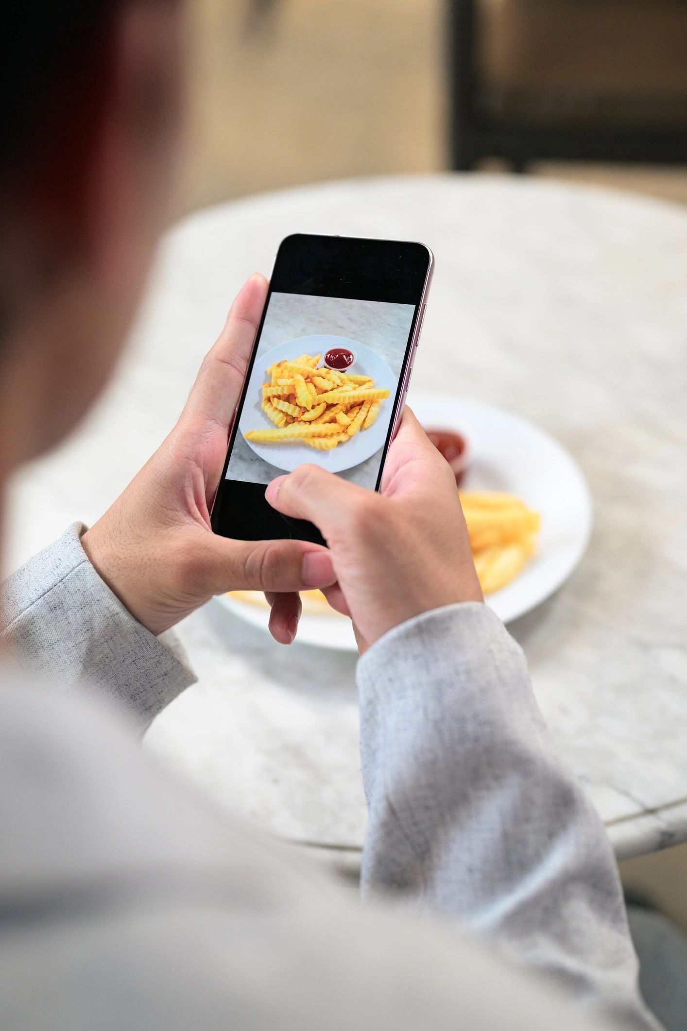 Customer using smartphone in a cafe setting